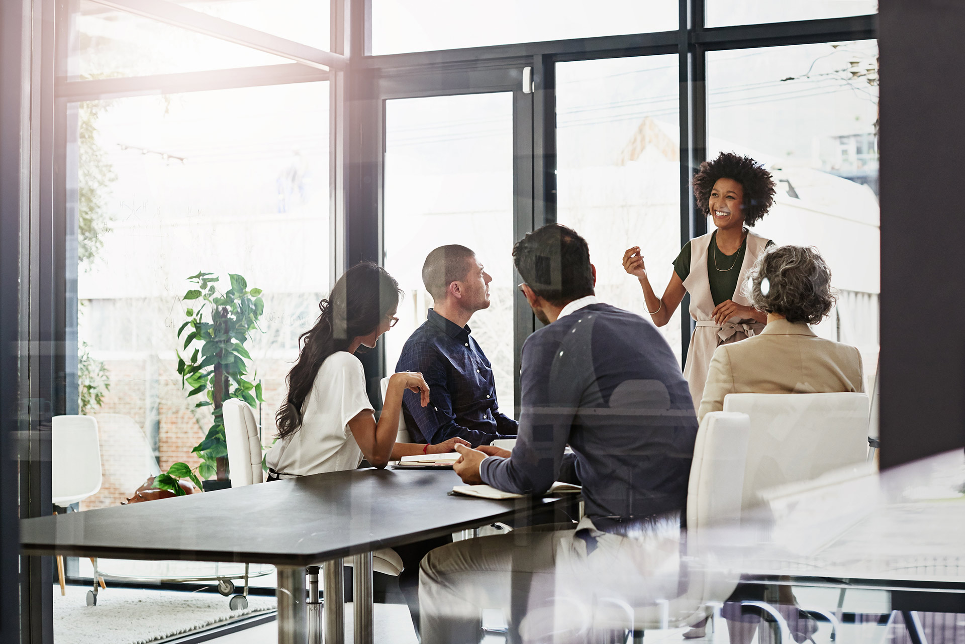 People at Desk in office of glass windows